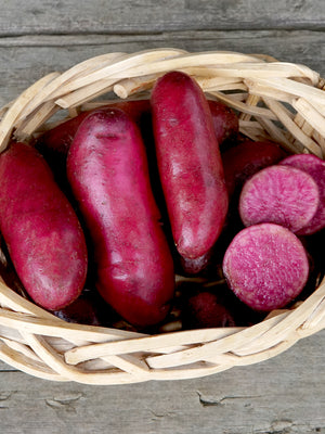 Basket of red potatoes on a wooden surface