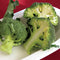 Close-up of Fiesta broccoli crowns showing bright green, tightly domed heads and pale stems on a white platter